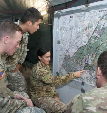 Four cadets studying a map