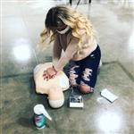 Student performs CPR. Student performs CPR.