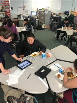 Teacher chatting with student using iPad with communication app 