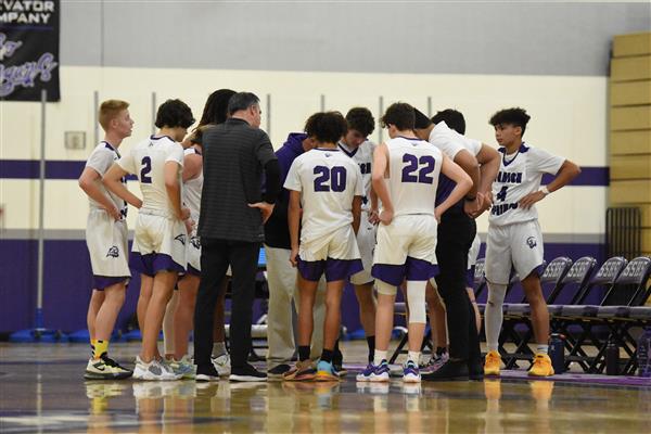 SSHS basketball team in a group meeting at a game 