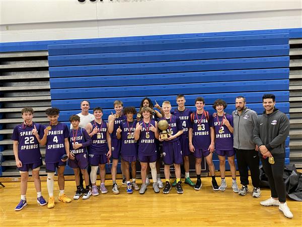 Boys Basketball team posing with their medals.