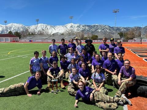 Spanish Springs Raiders Posing next to a trophy at the Douglas meet.
